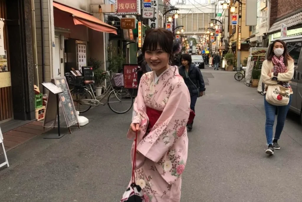 A woman wearing a rental kimono walking through the streets of Asakusa