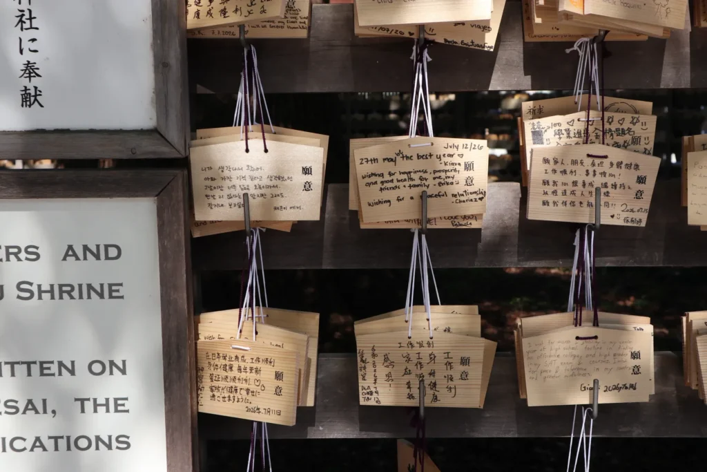 Wooden ema prayer plaques hanging on a display rack at a shrine