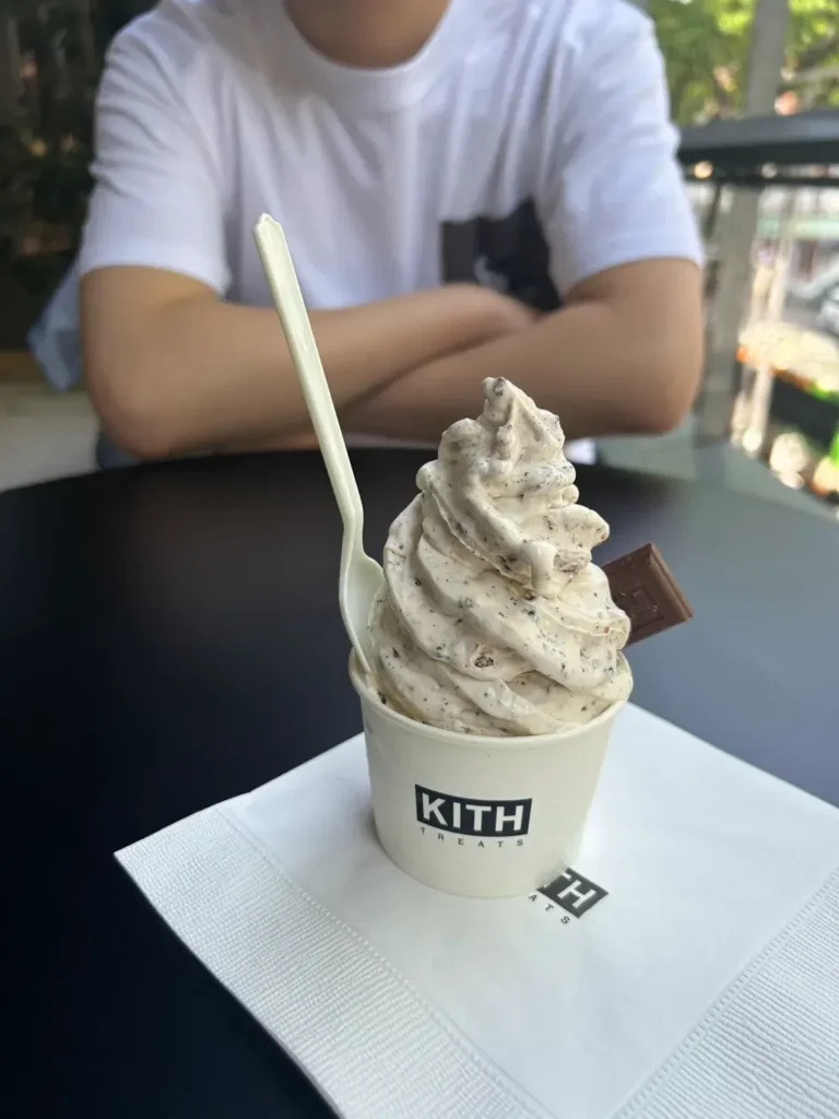 Soft-serve ice cream in a Kith Treats cup on a table