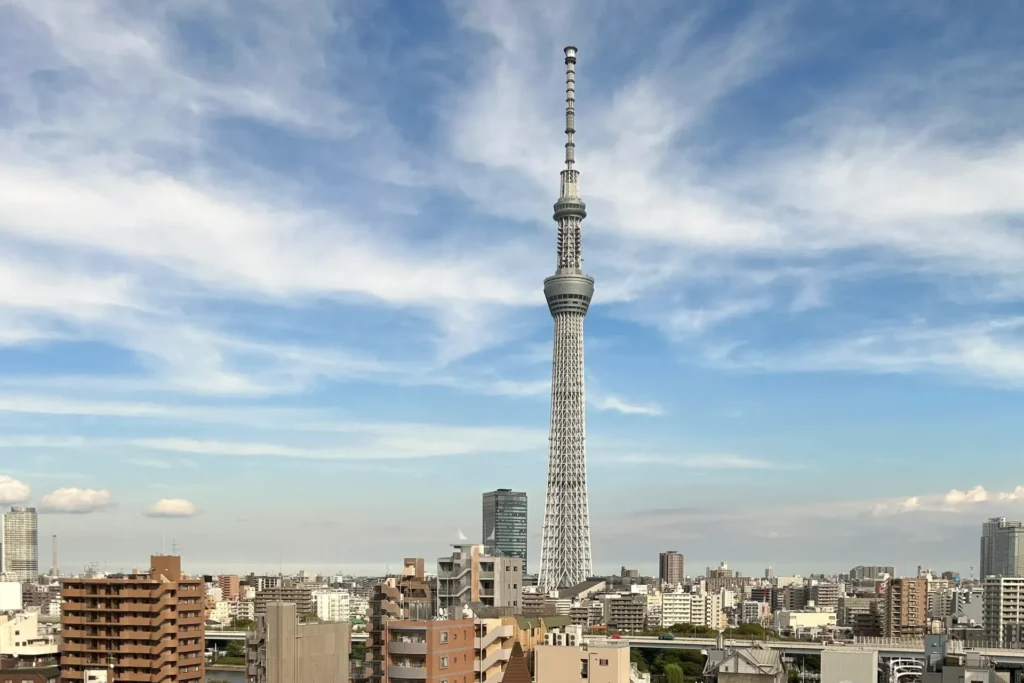Tokyo Skytree rising above the Asakusa cityscape under a blue sky viewed from OMO3 Asakusa