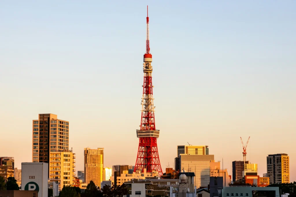 Tokyo Tower rising above city buildings in warm evening light