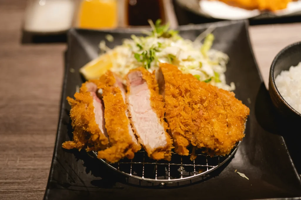 Thick-cut tonkatsu served with shredded cabbage and rice at Tonkatsu Kawamura