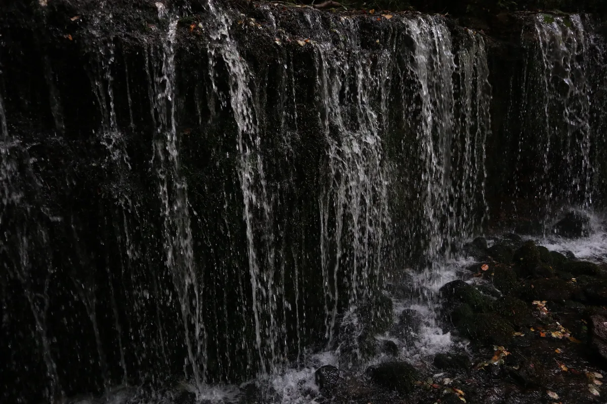 Close-up of water flowing down the rock face at Shiraito Falls.